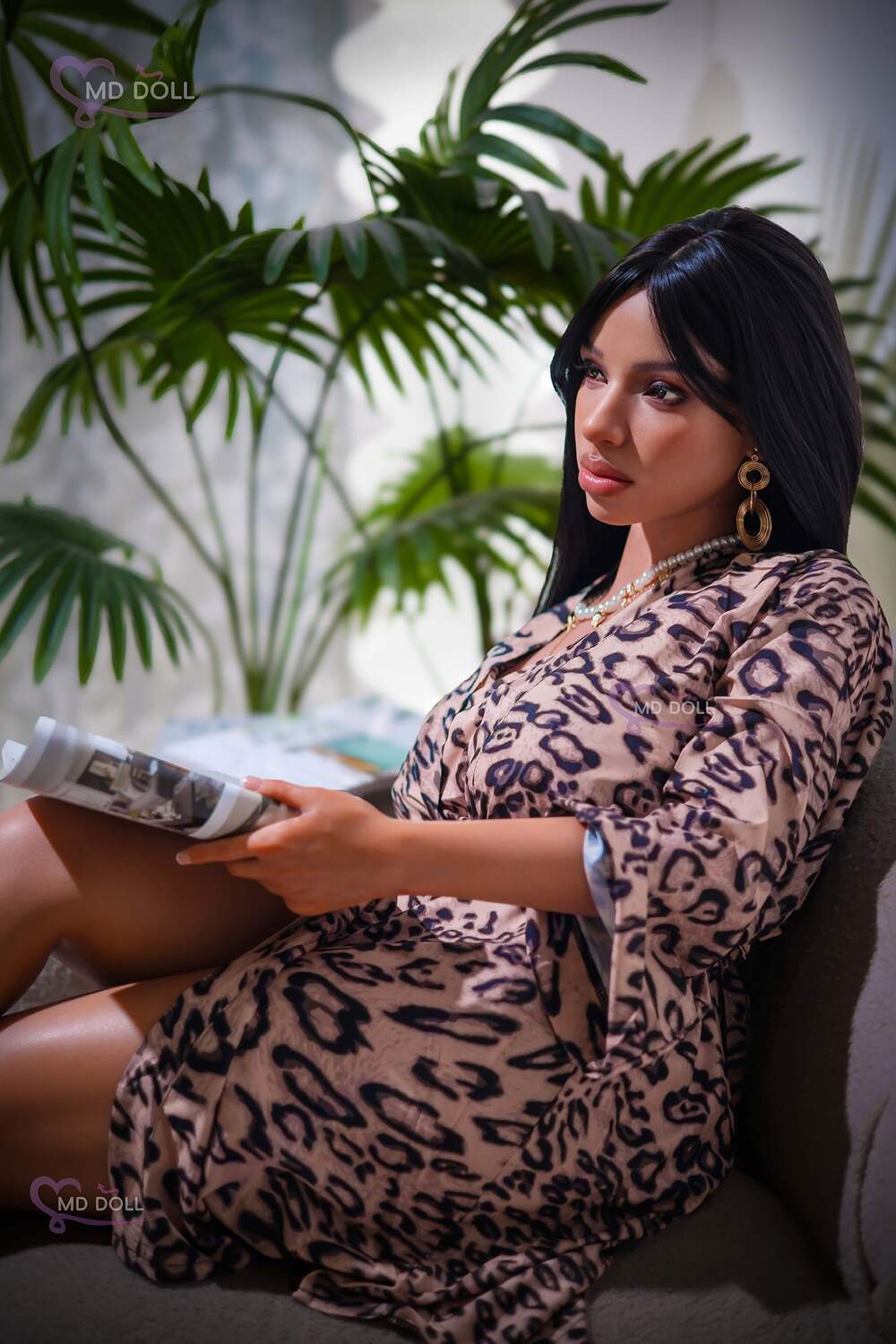 MD Doll Nia seated in a patterned robe holding reading material