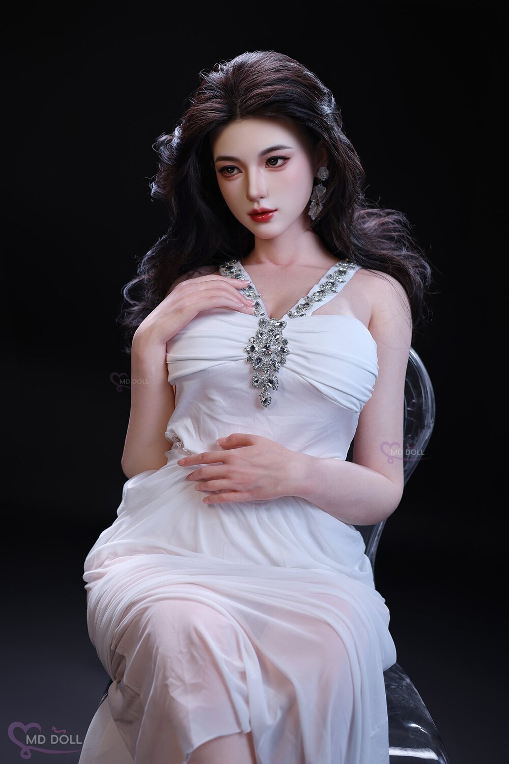 MD Doll Judy seated in a white embellished dress
